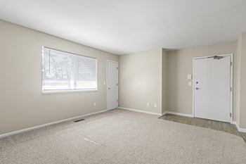 A room with a window and two doors.
